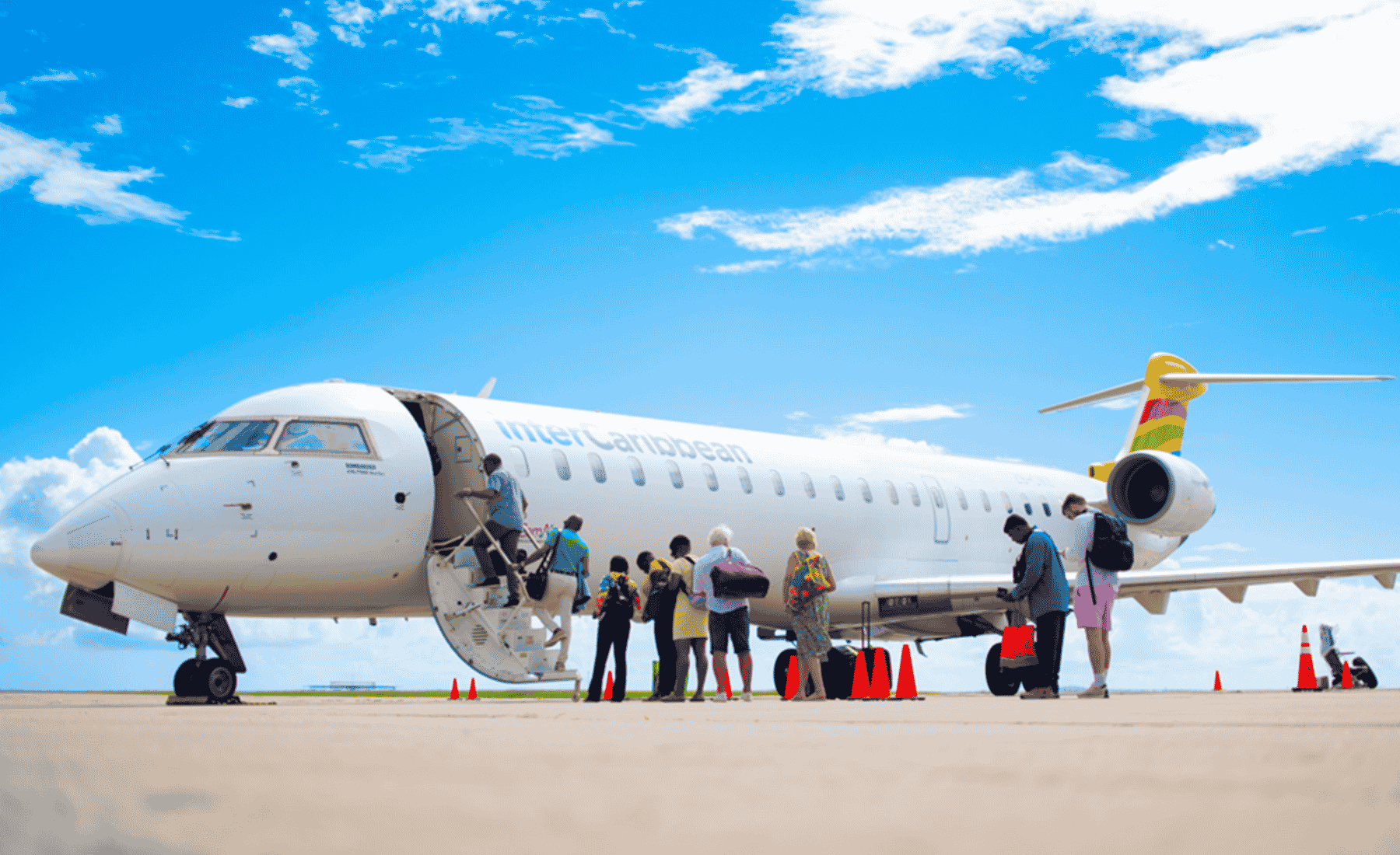 People boarding interCaribbean airplane with bags