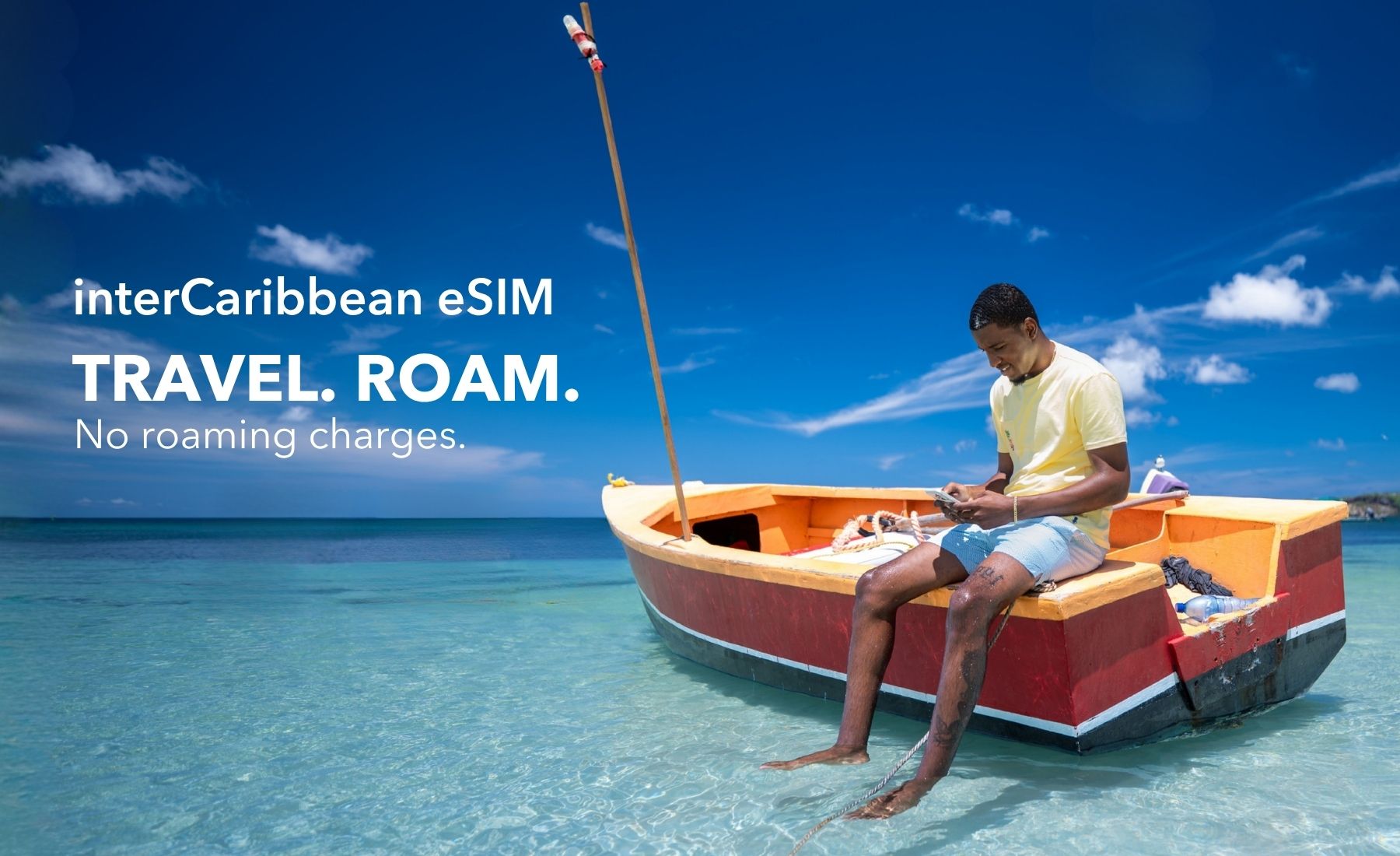 Man using a smartphone while sitting on a boat in the Caribbean.