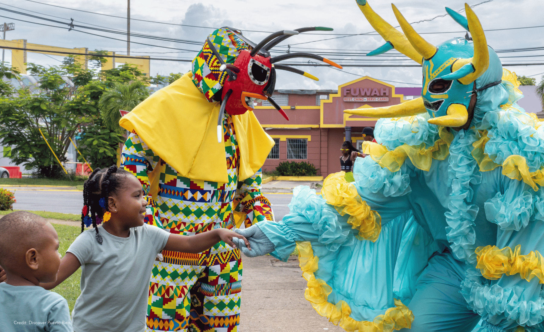 Carnival and people in costumes with masks in San Juan